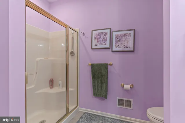a bathroom with a sink and mirror with toilet
