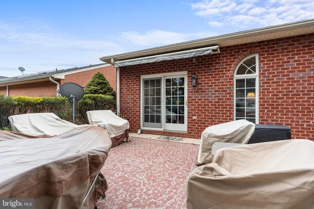 a view of a patio with a table and chairs