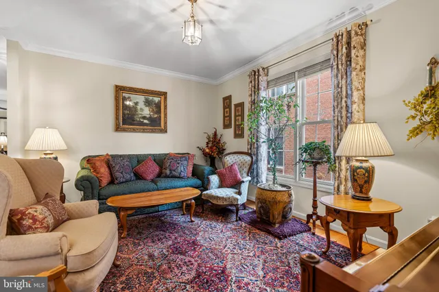a living room with furniture a lamp and a window