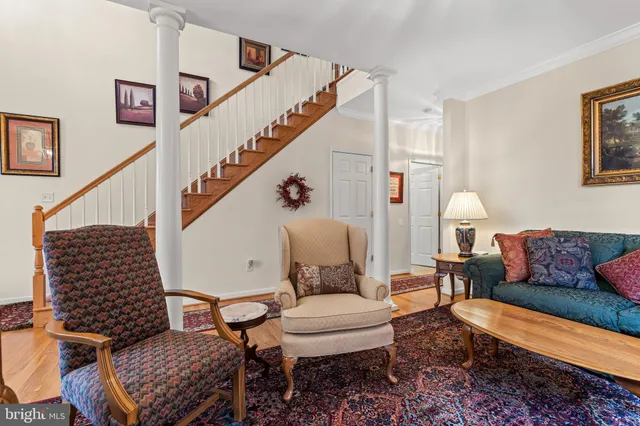 a living room with furniture and a stairs