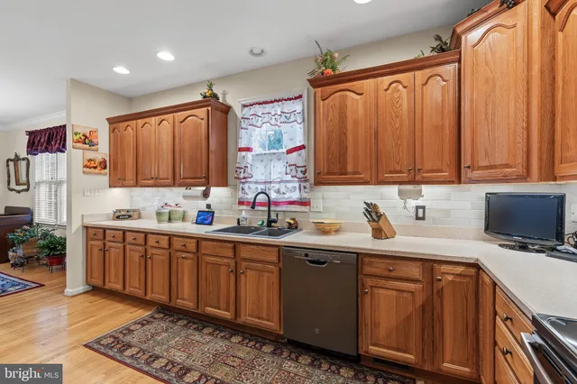 a kitchen with a sink a microwave and cabinets