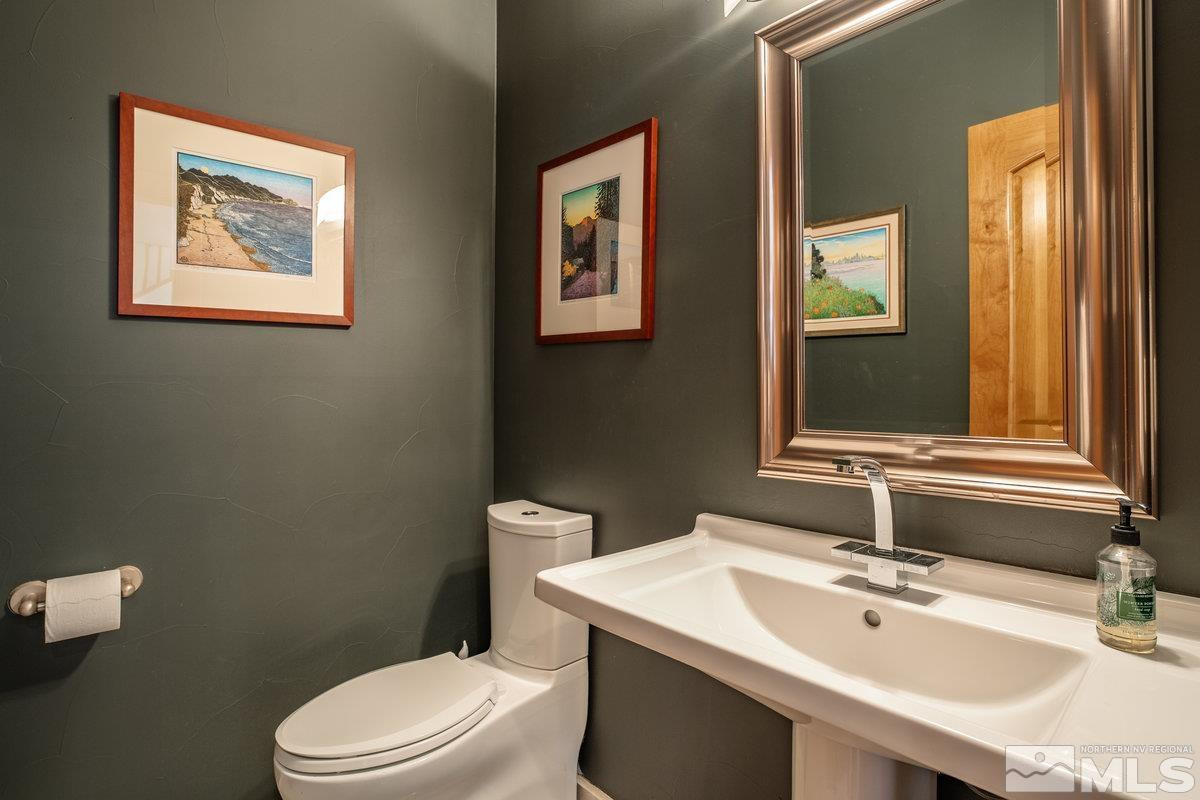 2147 The Back Road Glenbrook, NV 89413 - Photo 16 of 40 a bathroom with a toilet a sink and mirror
