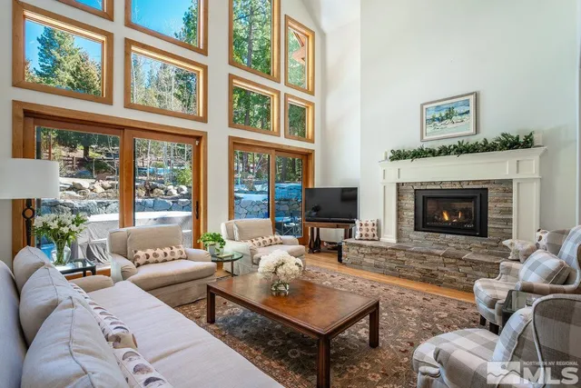 a living room with furniture a fireplace and windows