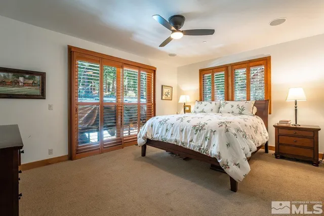 a bed sitting in a spacious bedroom next to a window