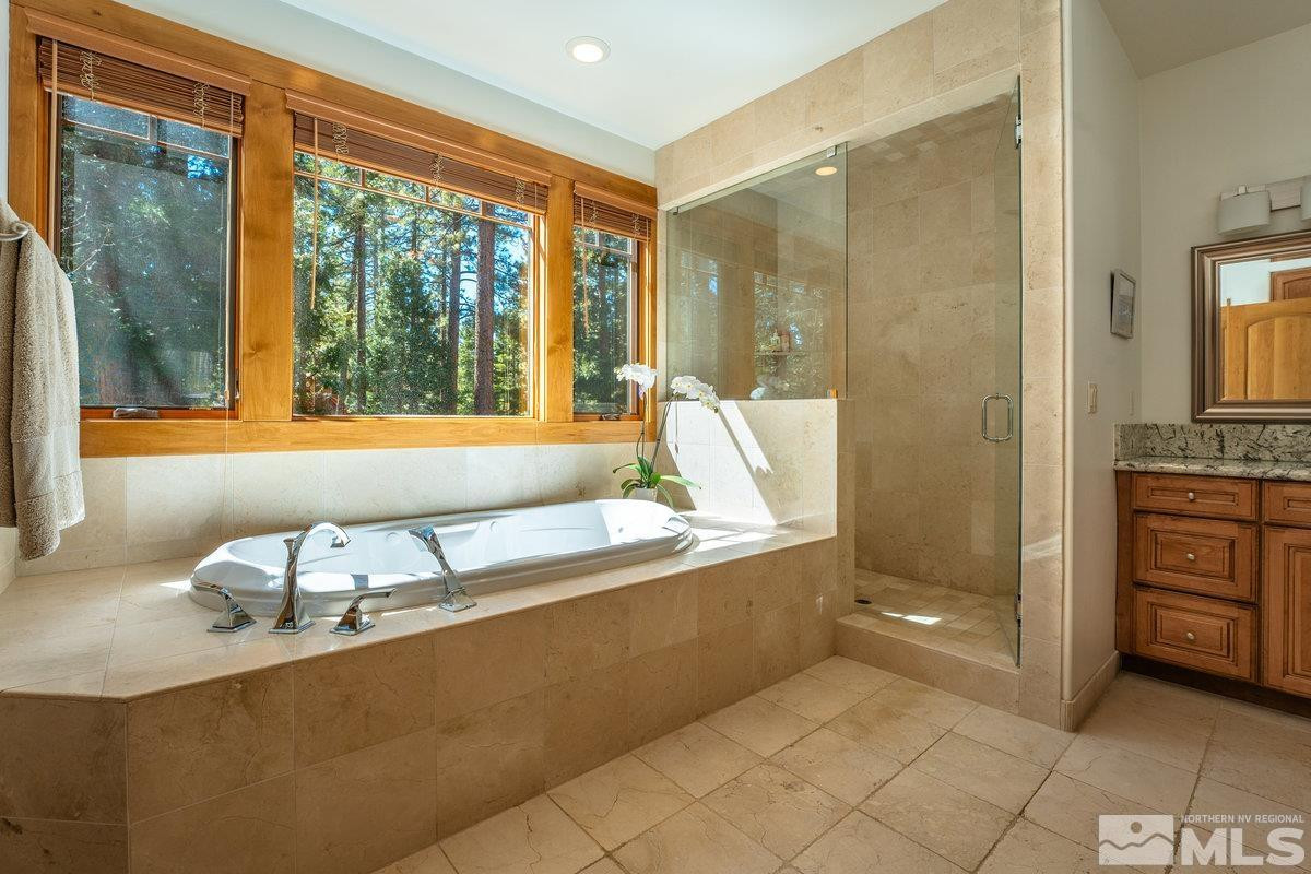 2147 The Back Road Glenbrook, NV 89413 - Photo 9 of 40 a bathroom with a tub sink and mirror