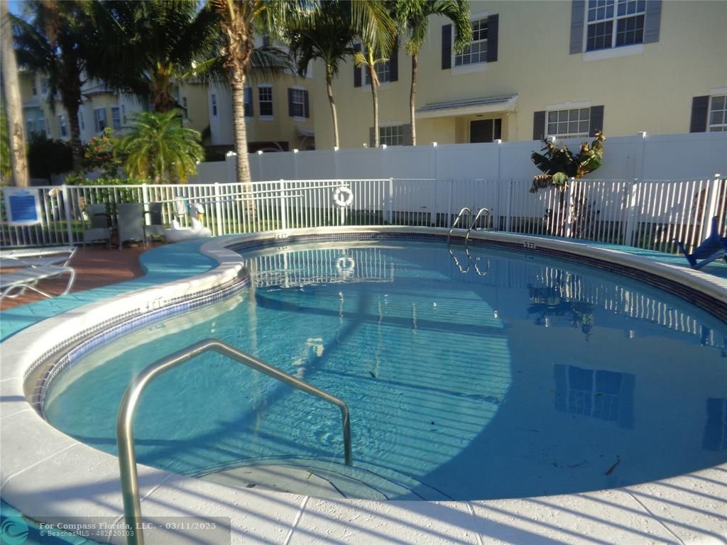 999 South Riverside Drive, Unit 202 Pompano Beach, FL 33062 - Photo 3 of 9 a view of a swimming pool with a patio