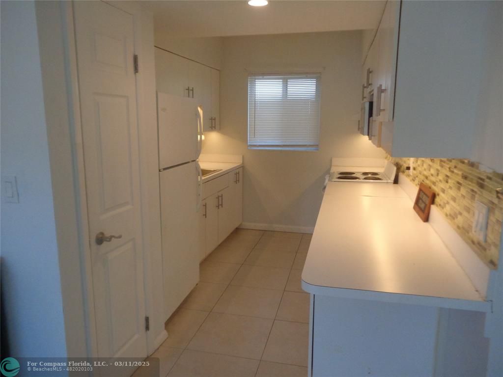 999 South Riverside Drive, Unit 202 Pompano Beach, FL 33062 - Photo 8 of 9 a view of a kitchen from the hallway