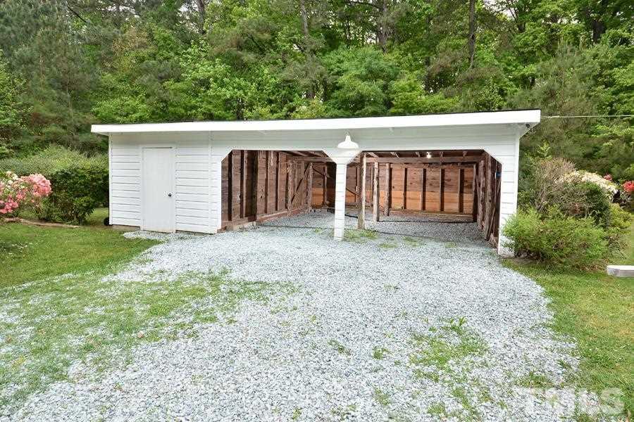 1703 Umstead Road Durham, NC 27712 - Photo 17 of 23 a view of a house with a yard and garage