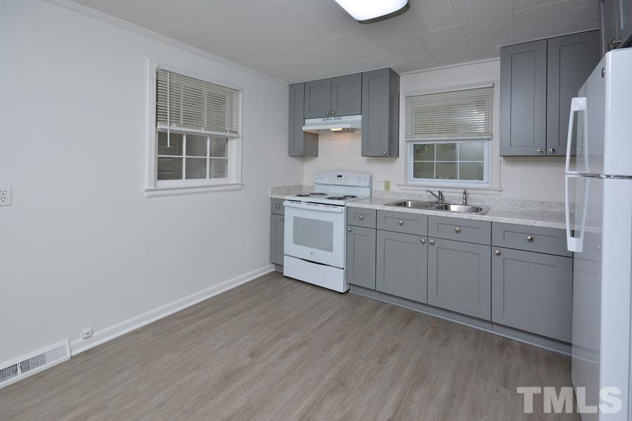 1703 Umstead Road Durham, NC 27712 - Photo 6 of 23 a kitchen with a sink cabinets and stainless steel appliances