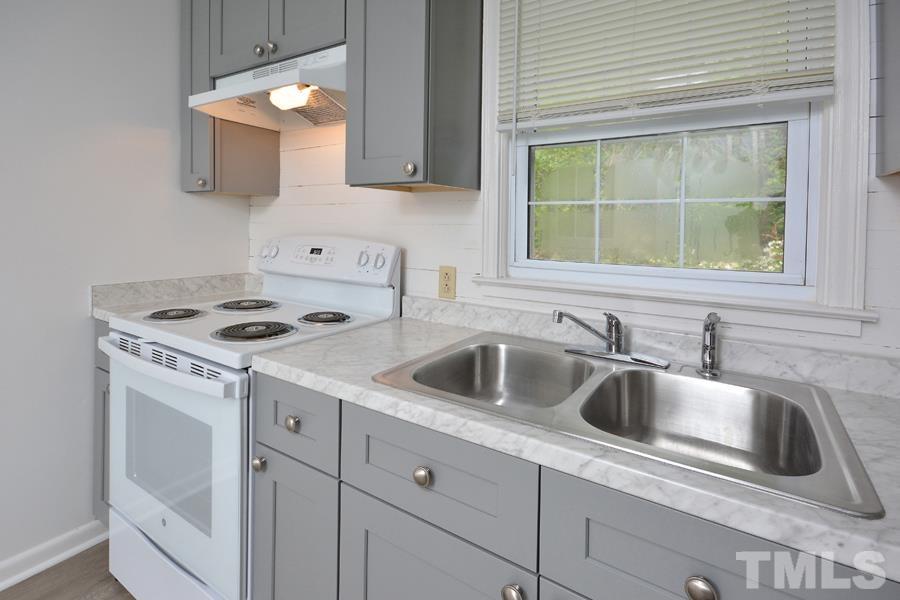 1703 Umstead Road Durham, NC 27712 - Photo 8 of 23 a kitchen with sink cabinets and window