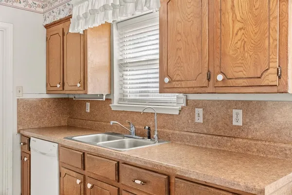 a kitchen with stainless steel appliances granite countertop white cabinets and a granite counter tops