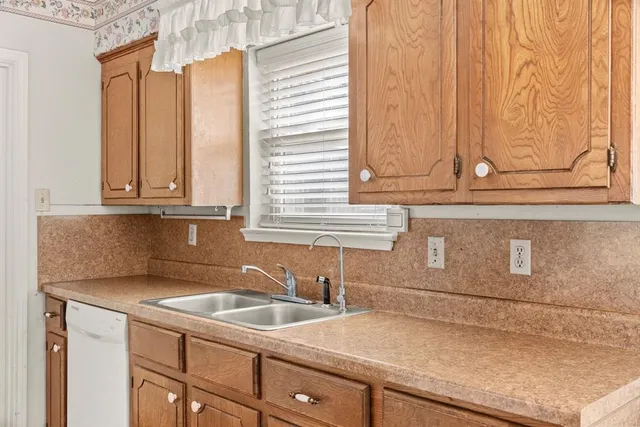 a kitchen with stainless steel appliances granite countertop white cabinets and a granite counter tops