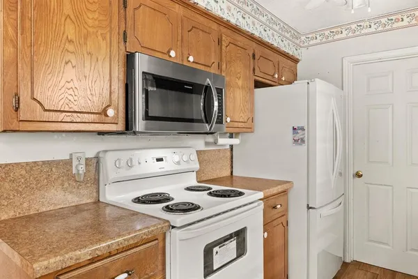 a kitchen with stainless steel appliances a stove a microwave and refrigerator