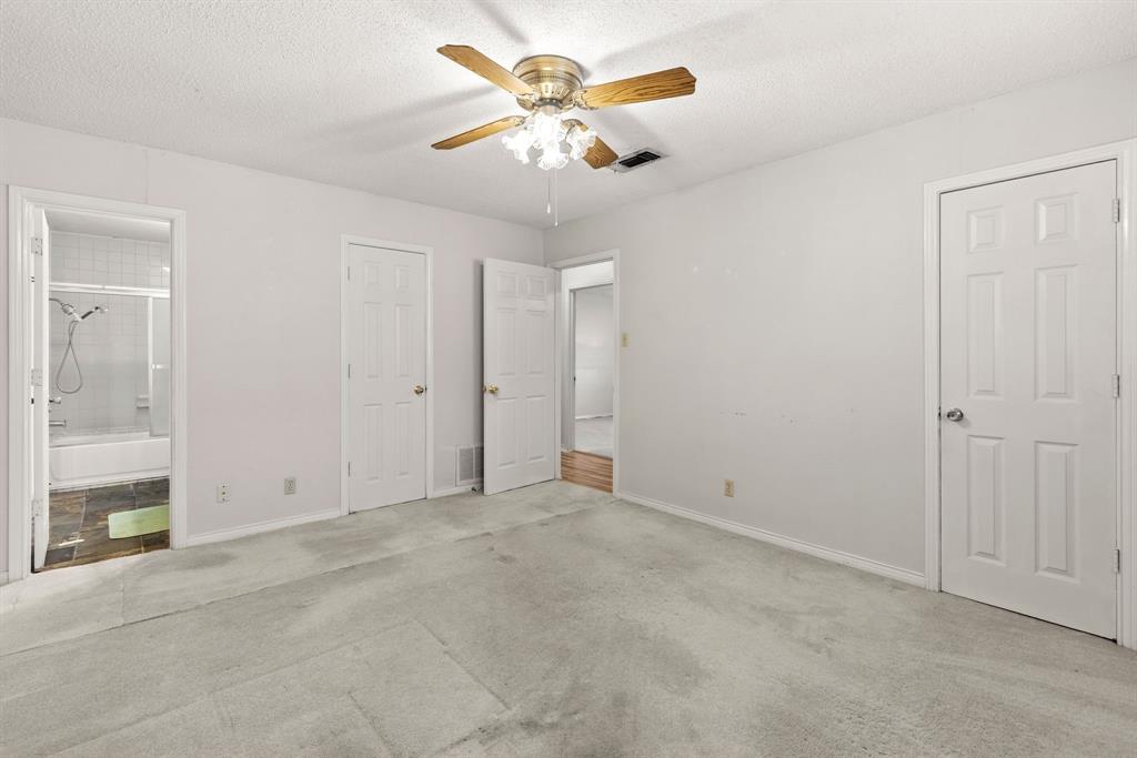 3013 Arapaho Road Commerce, TX 75428 - Photo 15 of 34 an empty room with closet and a chandelier fan
