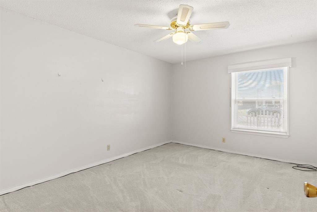 3013 Arapaho Road Commerce, TX 75428 - Photo 19 of 34 an empty room with a window