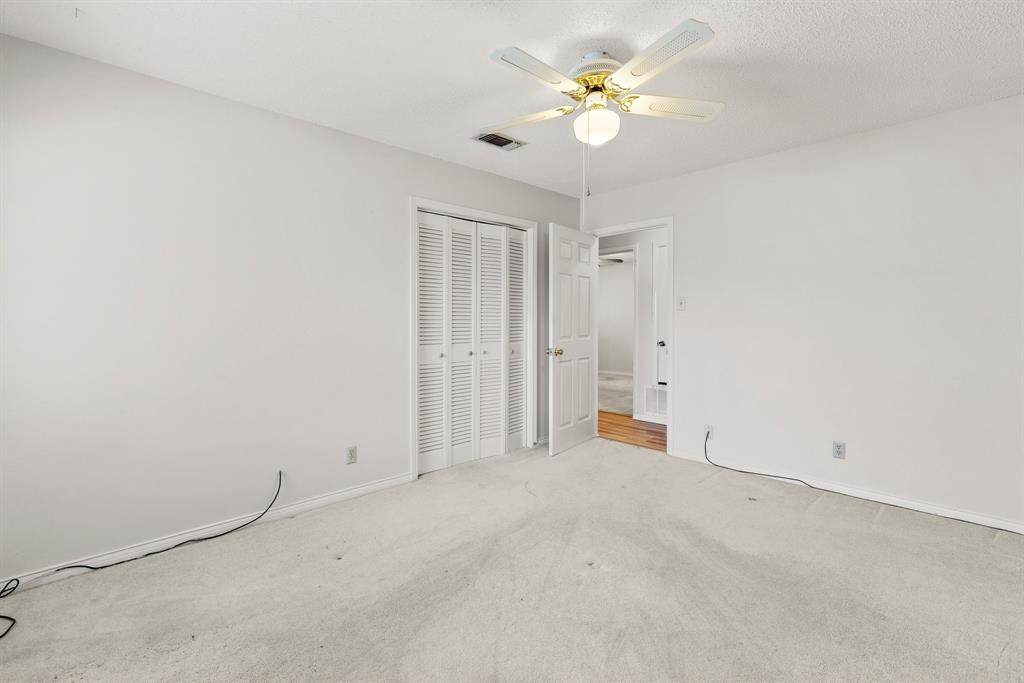 3013 Arapaho Road Commerce, TX 75428 - Photo 20 of 34 an empty room with a ceiling fan and a window