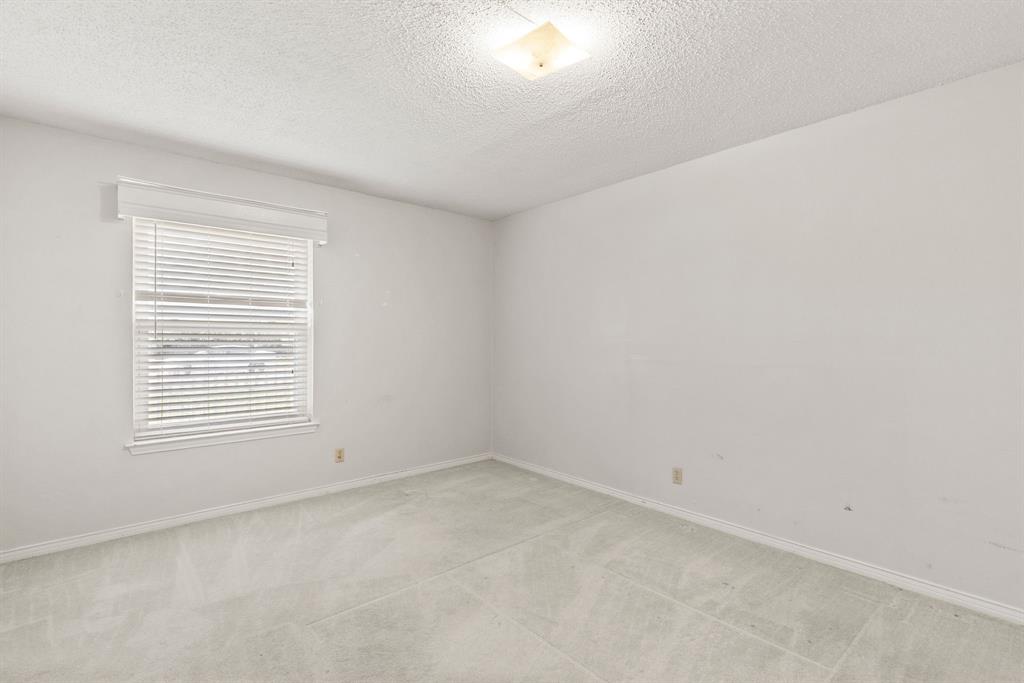 3013 Arapaho Road Commerce, TX 75428 - Photo 21 of 34 an empty room with a window