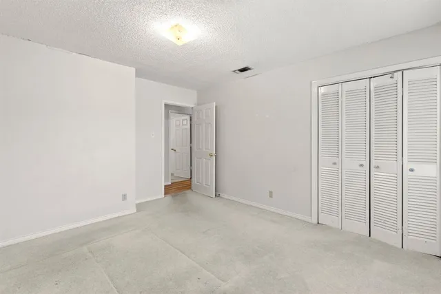 an empty room with closet area