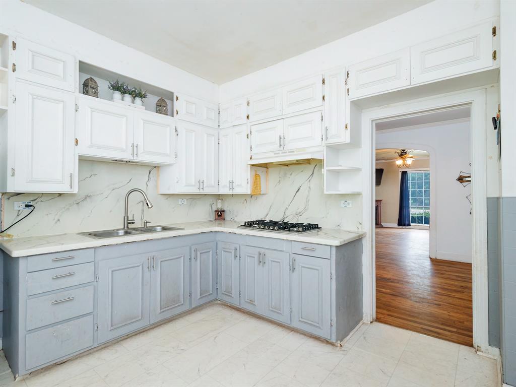 510 South Main Street Rising Star, TX 76471 - Photo 29 of 40 a kitchen with stainless steel appliances granite countertop a sink and cabinets