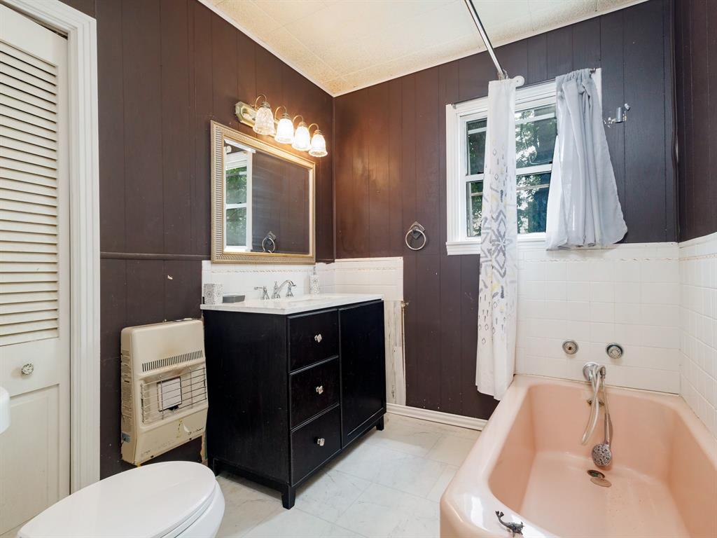 510 South Main Street Rising Star, TX 76471 - Photo 33 of 40 a bathroom with a tub sink and mirror
