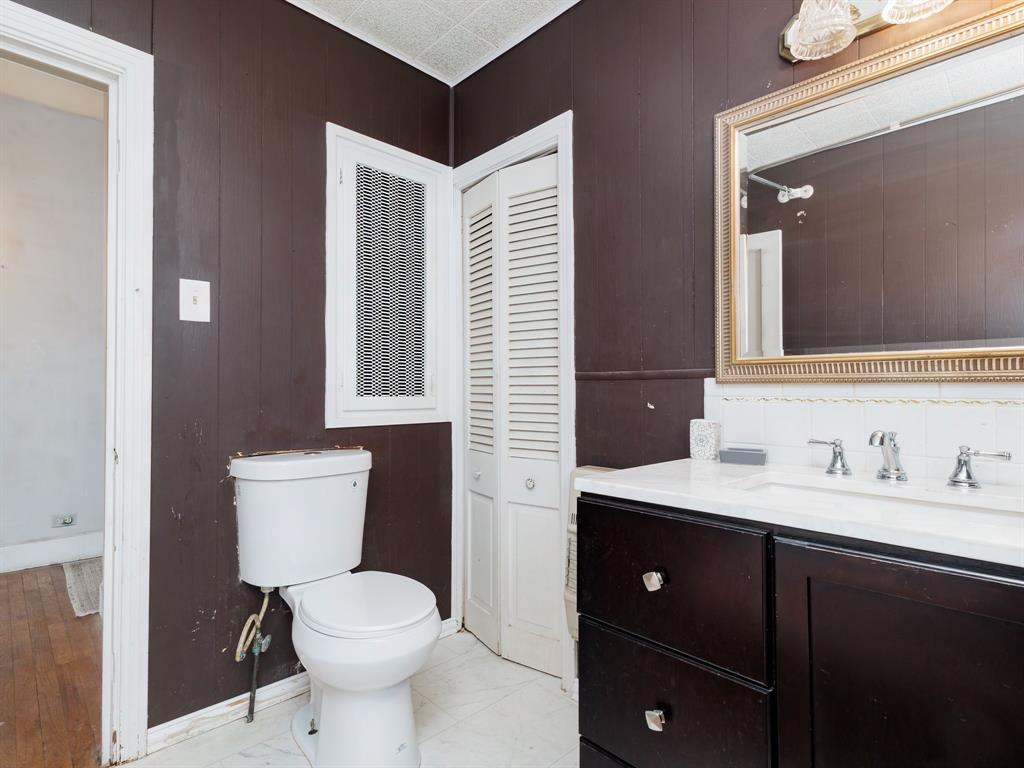 510 South Main Street Rising Star, TX 76471 - Photo 34 of 40 a bathroom with a toilet sink and mirror