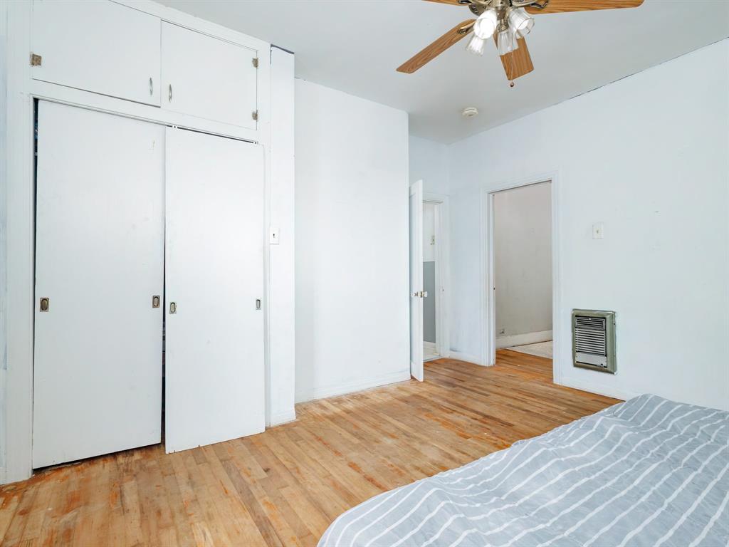 510 South Main Street Rising Star, TX 76471 - Photo 37 of 40 a bedroom with a bed and a chandelier
