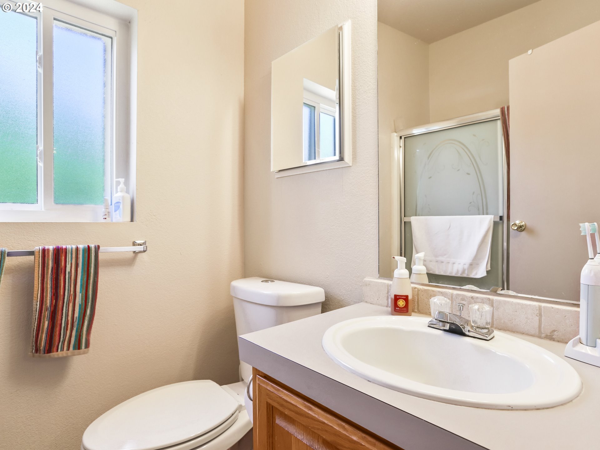 900 Northeast Francis Avenue Gresham, OR 97030 - Photo 11 of 16 a bathroom with a sink a toilet and mirror