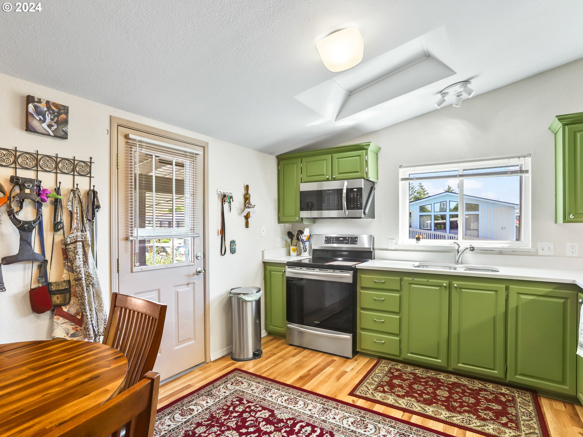 900 Northeast Francis Avenue Gresham, OR 97030 - Photo 6 of 16 a kitchen with stainless steel appliances kitchen island granite countertop a sink and cabinets