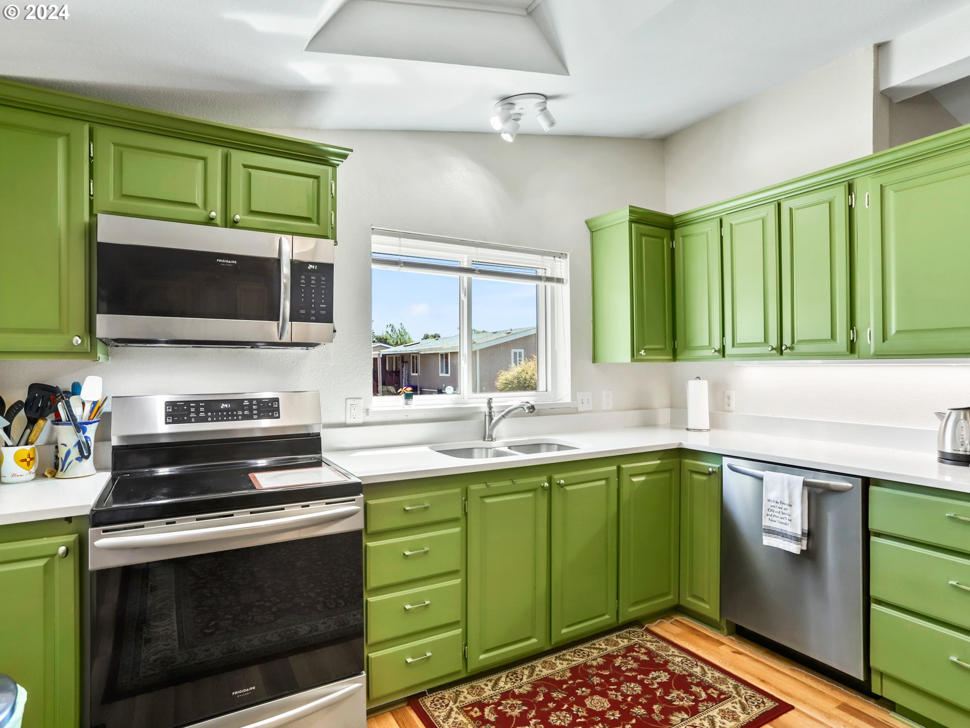 900 Northeast Francis Avenue Gresham, OR 97030 - Photo 8 of 16 a kitchen with a sink stove top oven and microwave
