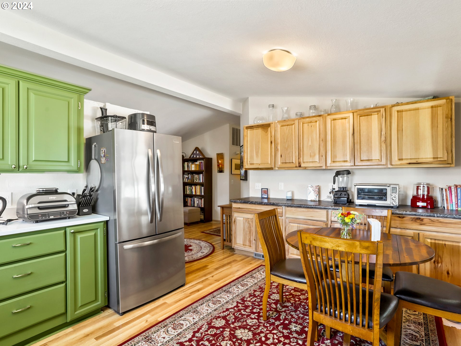 900 Northeast Francis Avenue Gresham, OR 97030 - Photo 9 of 16 a kitchen with stainless steel appliances granite countertop a refrigerator a stove top oven and a sink with couches