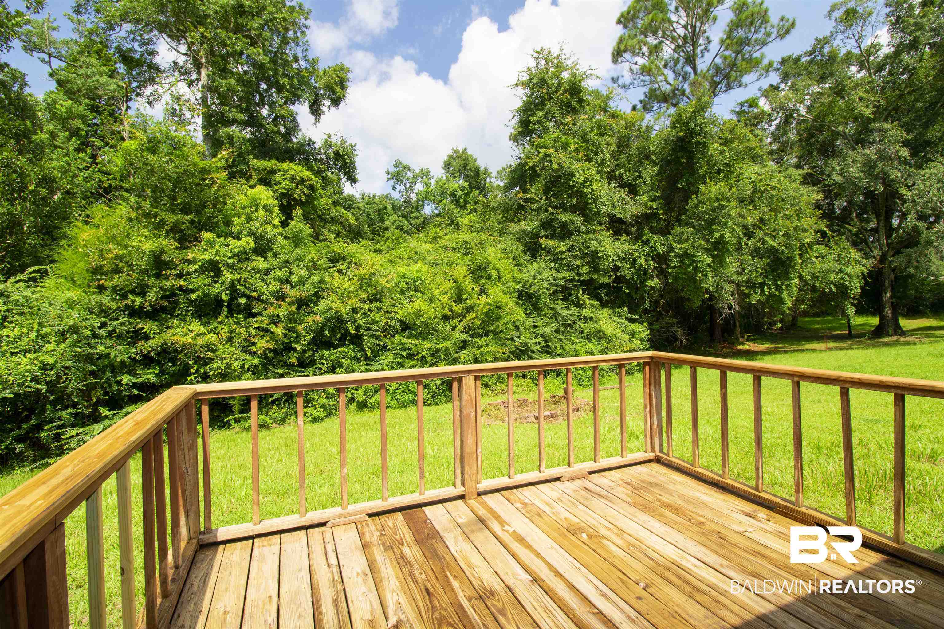 13255 Pointer Drive West Foley, AL 36535 - Photo 2 of 25 Wooden deck featuring a lawn