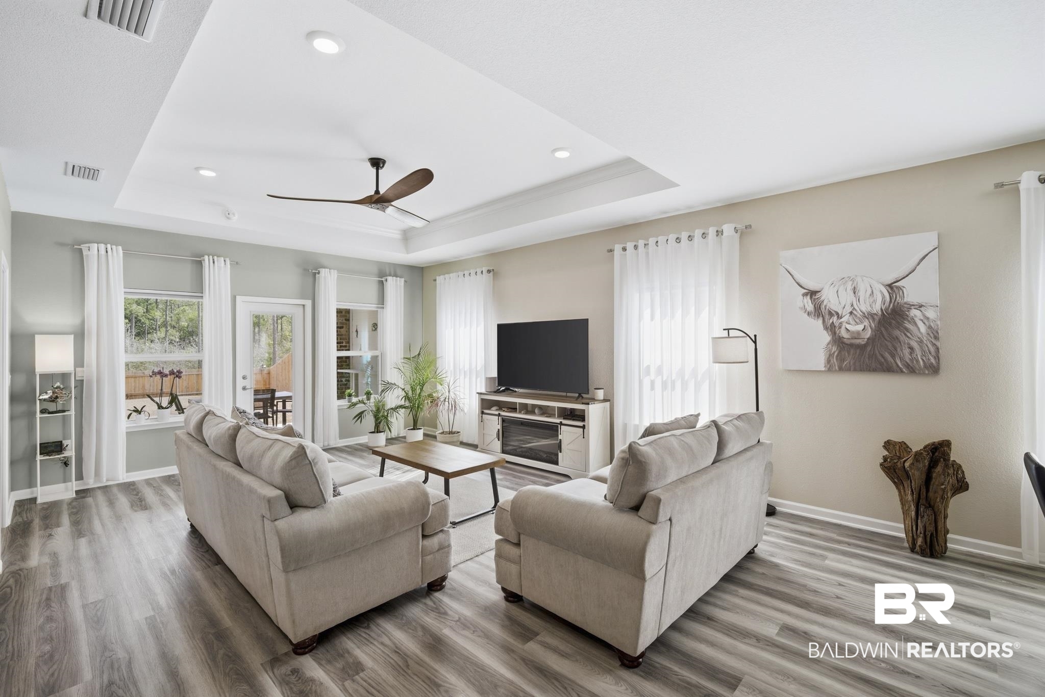 13887 Antler Hl Road Daphne, AL 36527 - Photo 5 of 50 Living area with ceiling fan, wood finished floors, recessed lighting, and a tray ceiling