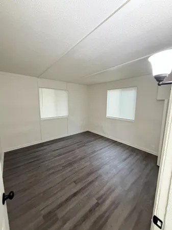 a kitchen with granite countertop cabinets and white appliances