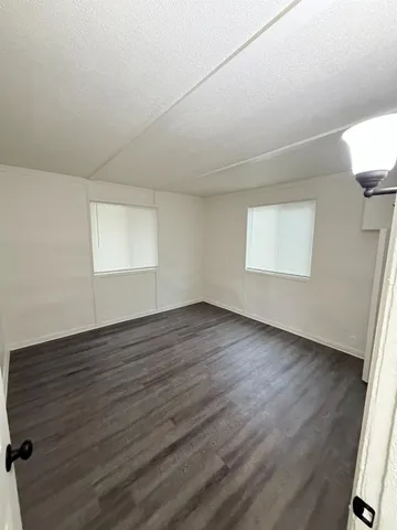 a kitchen with granite countertop cabinets and white appliances