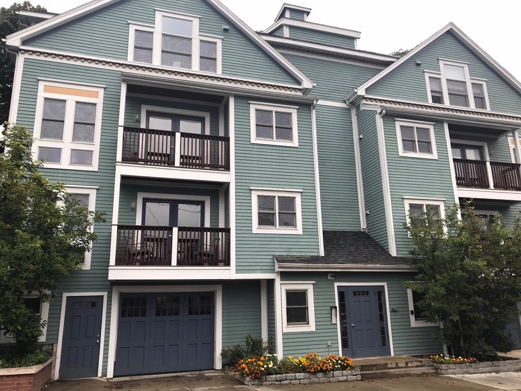 a front view of a residential apartment building with a yard