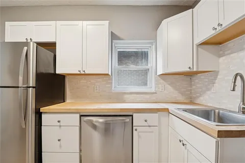 a kitchen with a stove and a refrigerator