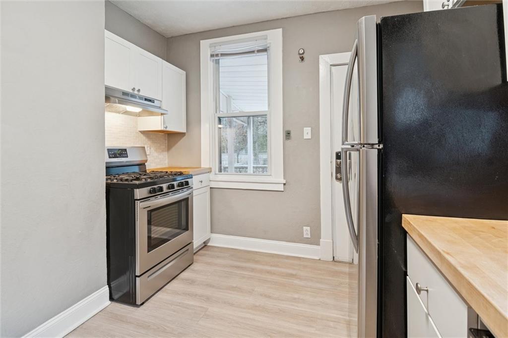 3518 Beechwood Boulevard Pittsburgh, PA 15217 - Photo 16 of 34 a kitchen with a stove and a refrigerator