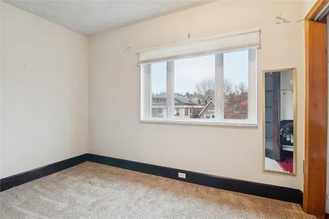 an empty room with windows and closet