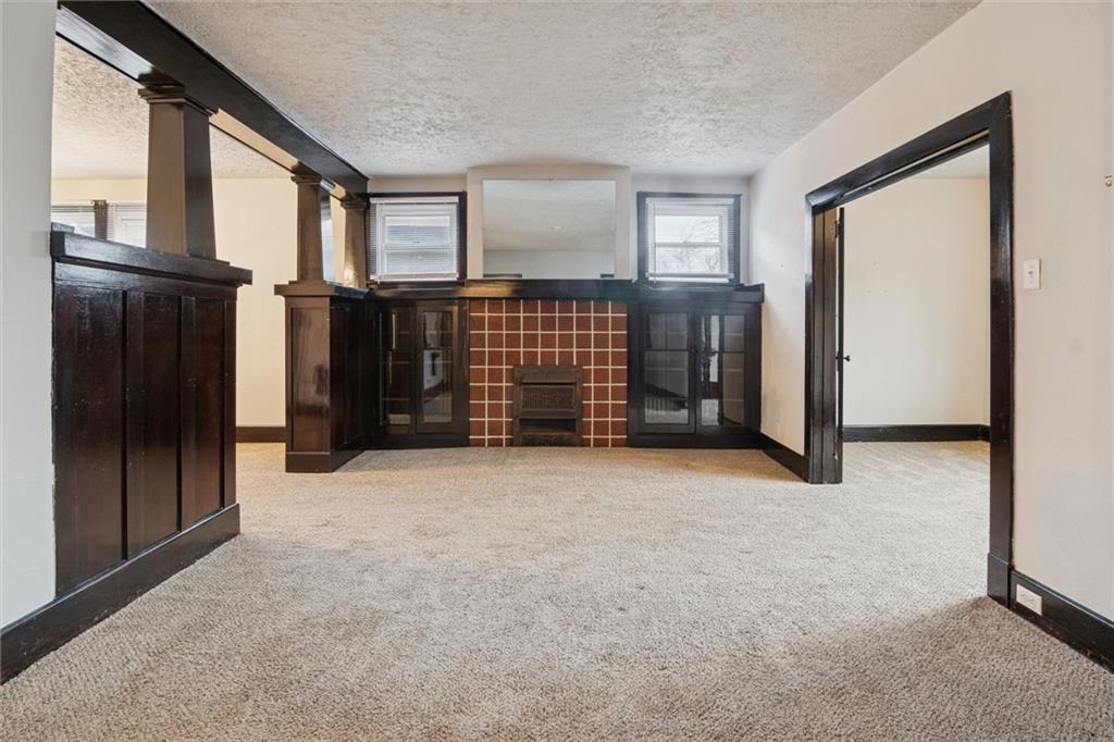 3518 Beechwood Boulevard Pittsburgh, PA 15217 - Photo 5 of 34 a view of an empty room with a fireplace and windows