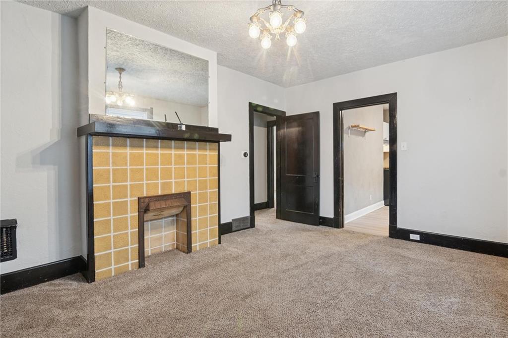 3518 Beechwood Boulevard Pittsburgh, PA 15217 - Photo 9 of 34 an empty room with fireplace and windows