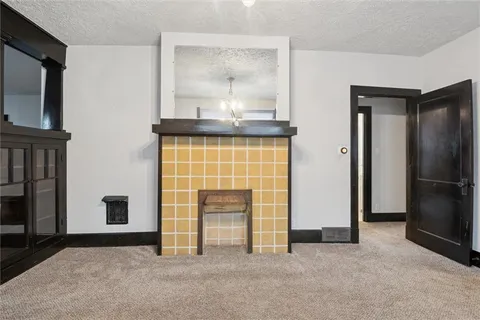 an empty room with furniture and a fireplace