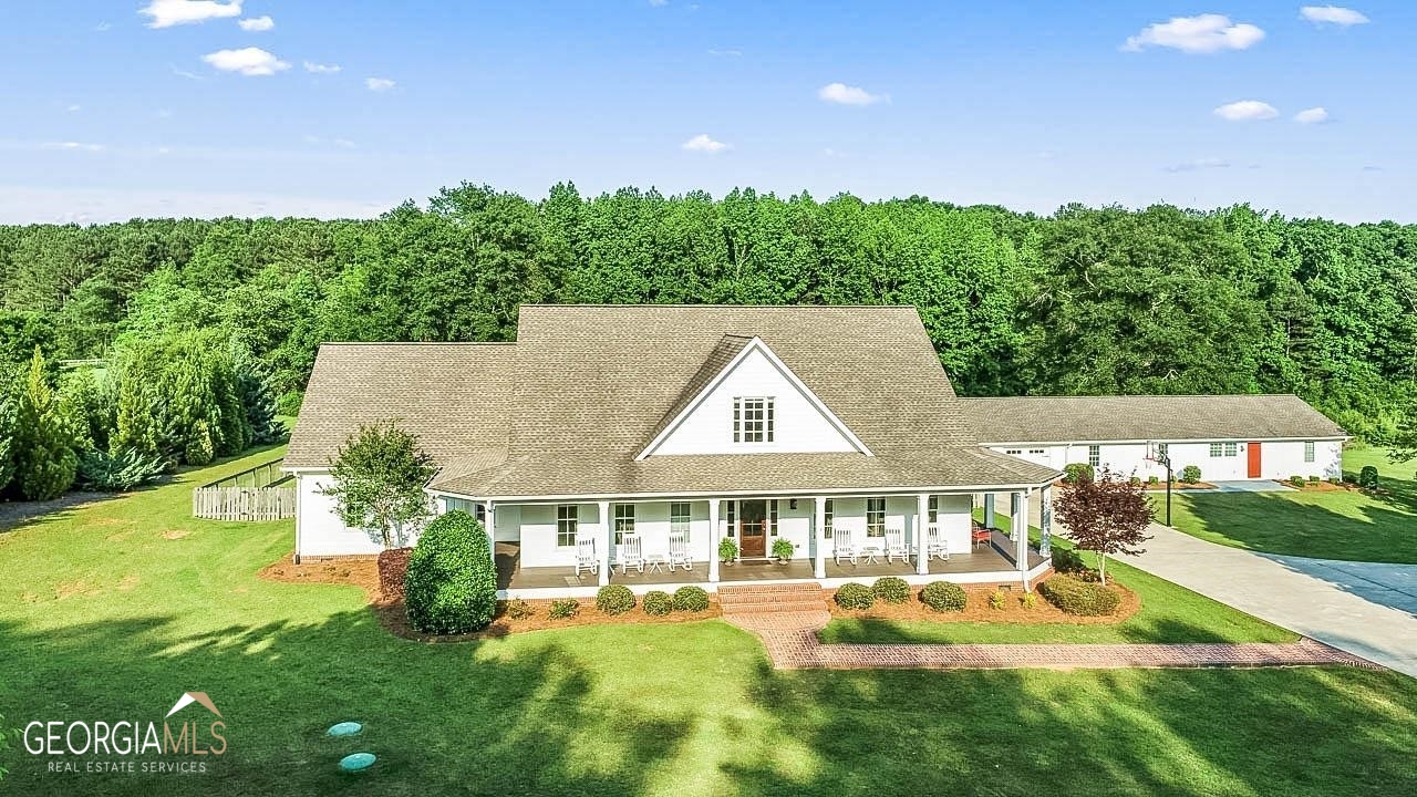 135 Long Branch Road Locust Grove, GA 30248 - Photo 1 of 1 a aerial view of a house with swimming pool having outdoor seating
