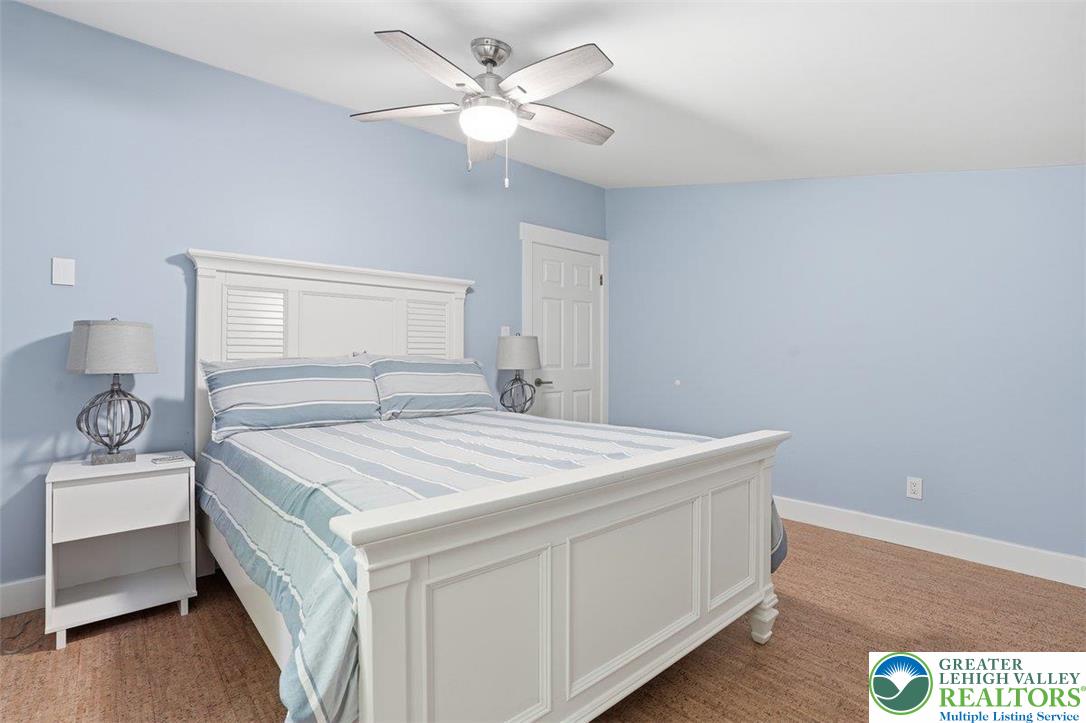 2288 Mulberry Road Fogelsville, PA 18051 - Photo 14 of 35 a bedroom with a bed and a chandelier