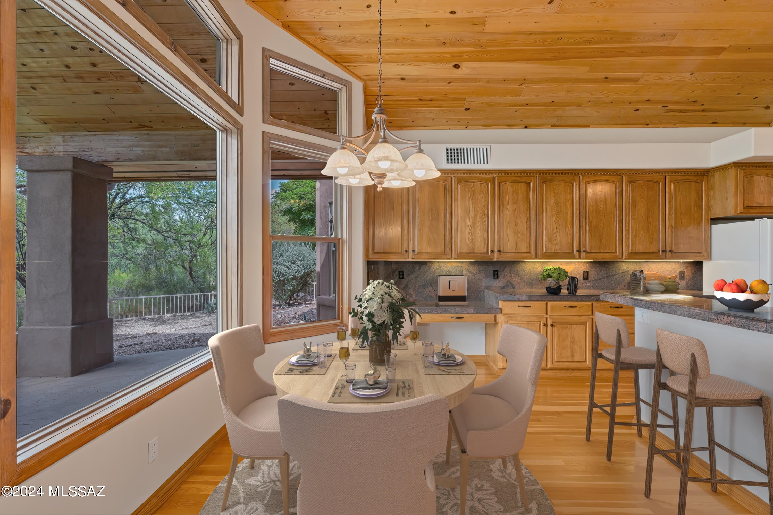 4001 North Harrison Road Tucson, AZ 85749 - Photo 19 of 50 a dining room with furniture and wooden floor