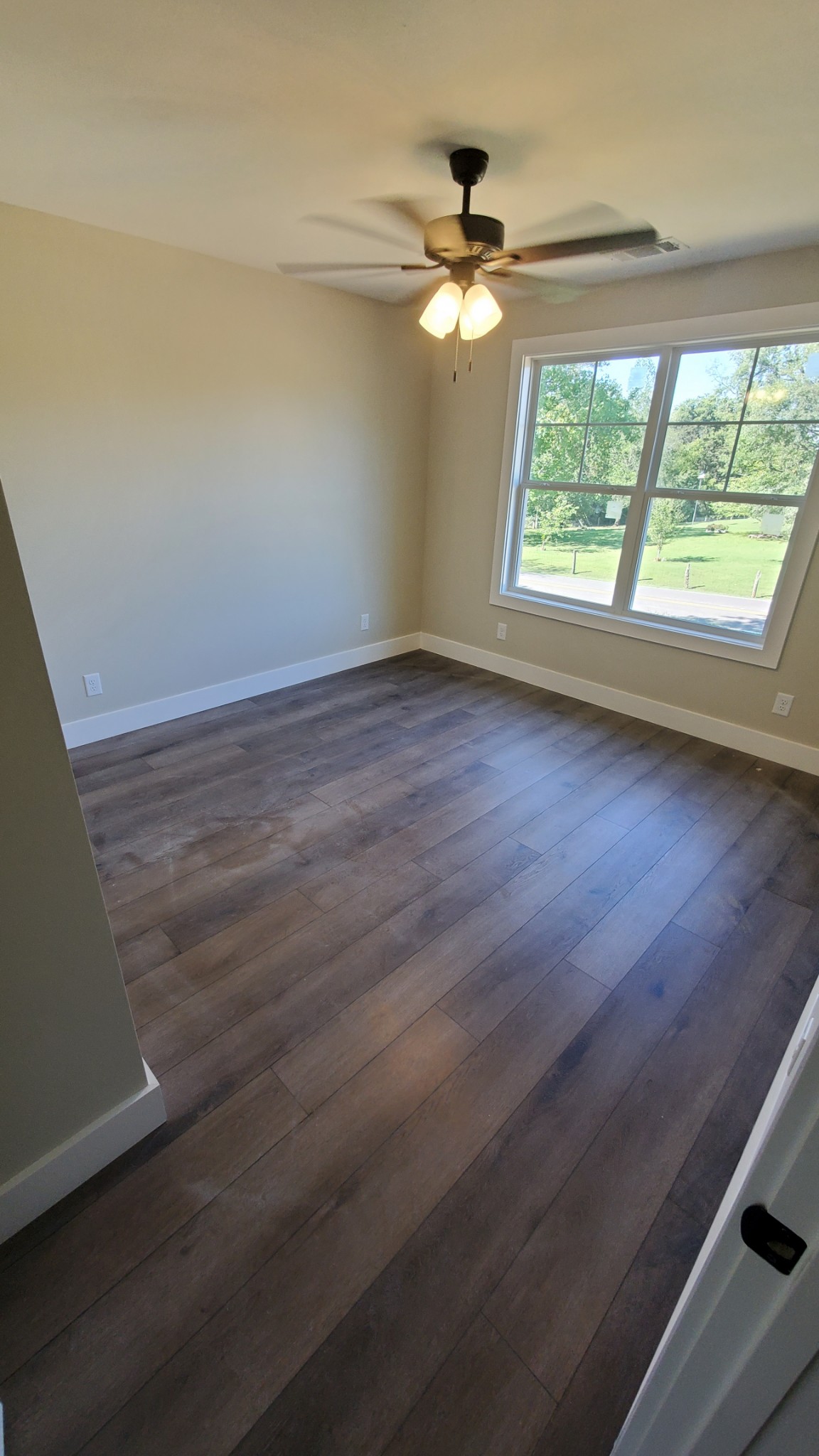 4000 Beasleys Bend Road Lebanon, TN 37087 - Photo 17 of 26 an empty room with wooden floor fan and windows