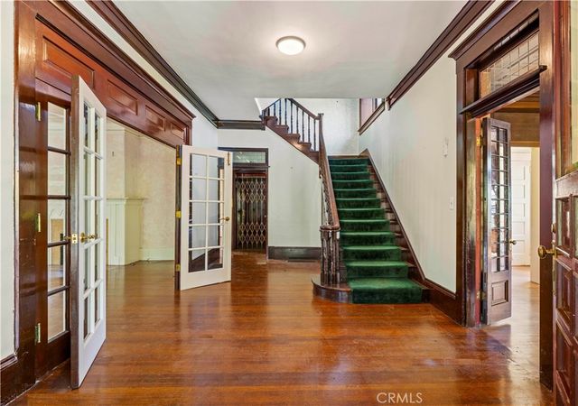 a view of an entryway with wooden floor and stairs