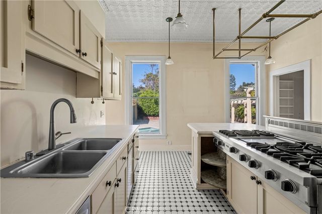 a bathroom with a granite countertop sink a mirror and a shower
