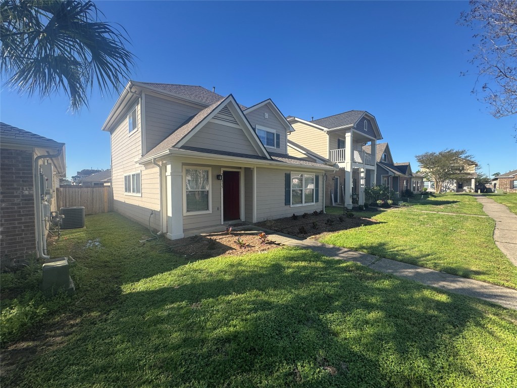 a front view of a house with yard and green space