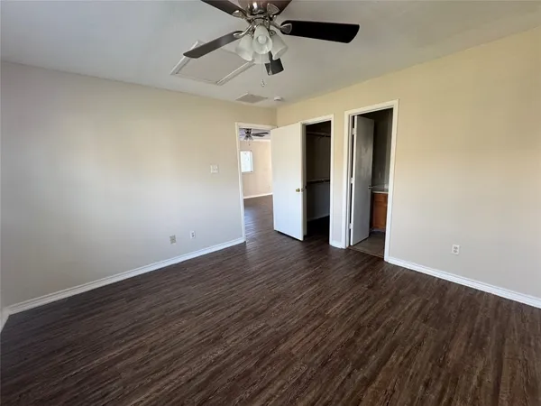 a view of a room with wooden floor