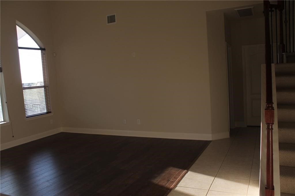 2513 Rusk Court Round Rock, TX 78665 - Photo 20 of 39 Spare room with stairs and dark wood-style floors